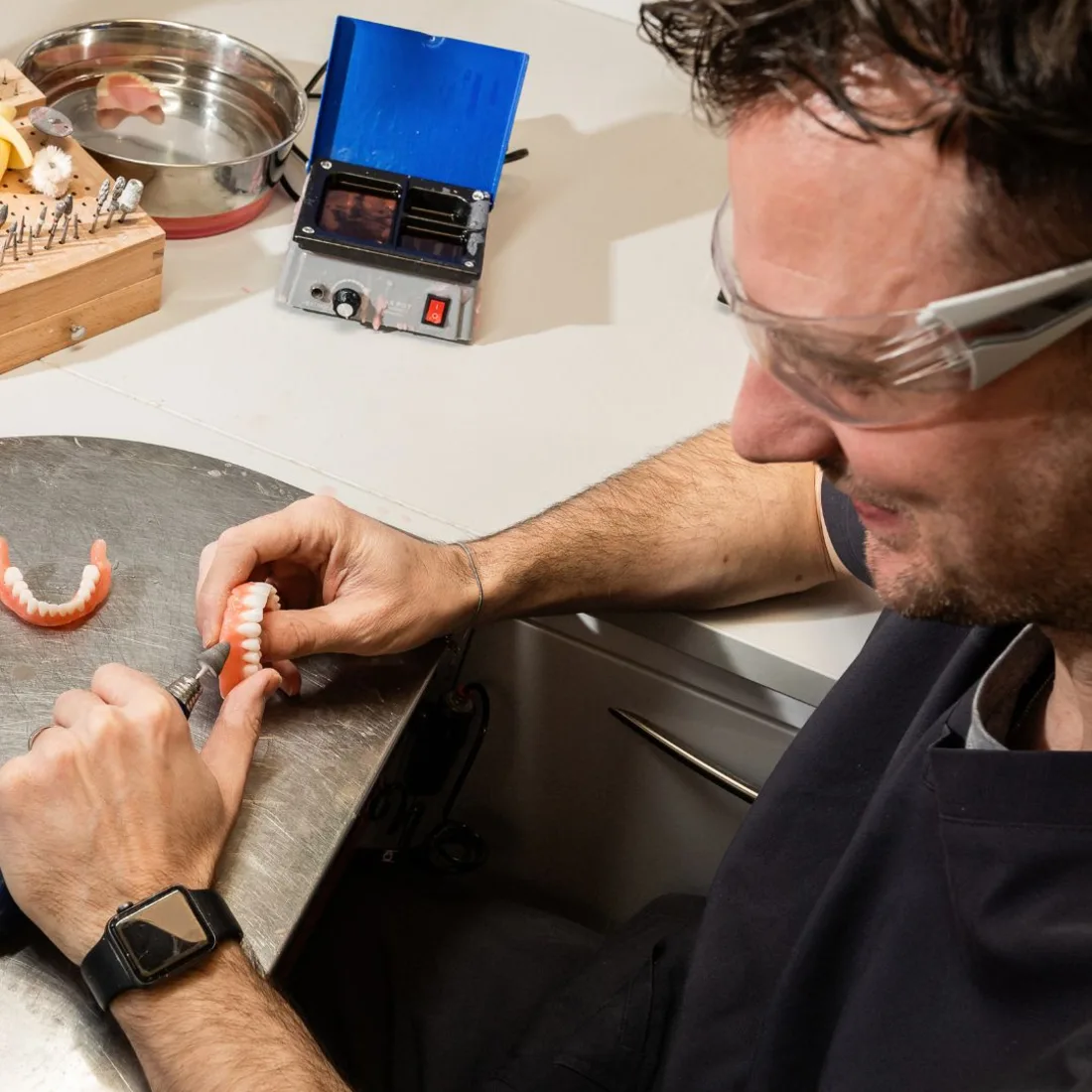 Patient caring for their dentures at home